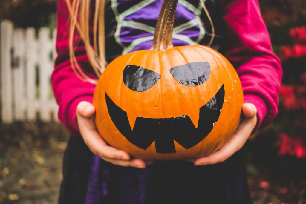 girl holding a pumpkin