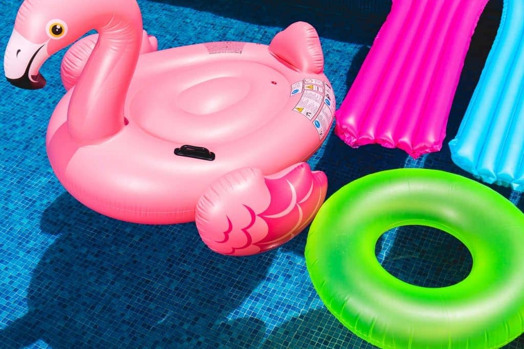 pool flamingo float surrounded by other floats